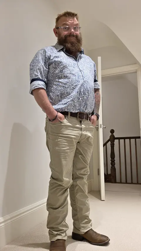 Paul Willard smiling in a patterned shirt